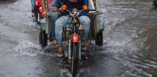 Young Man Pedals Through Flood To Give Elderly Pedicab Driver A Rest
